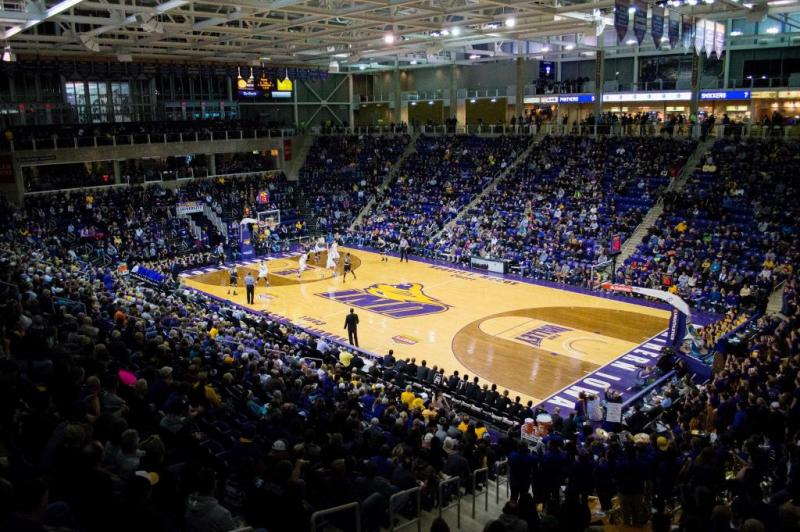 Vibrant basketball court with a bustling crowd in full stands
