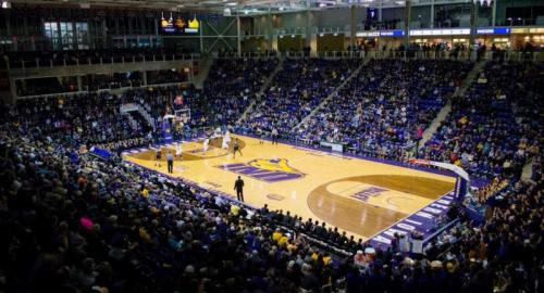 Vibrant basketball court with a bustling crowd in full stands